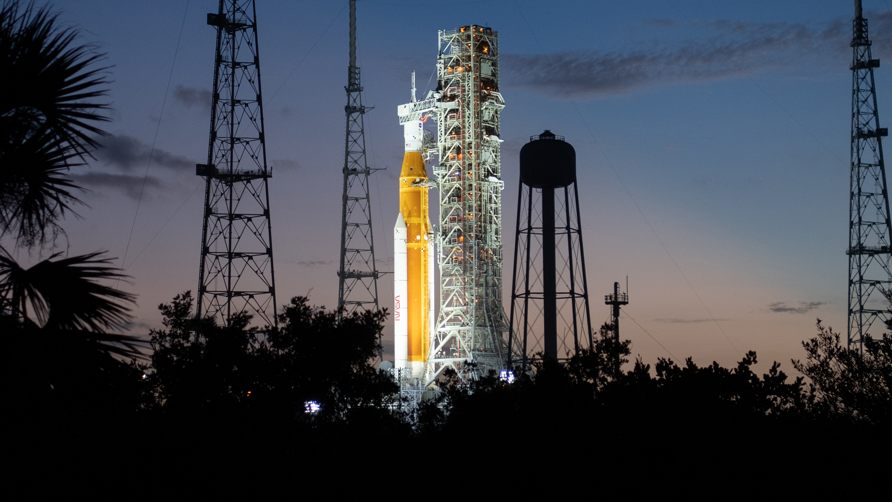 NASA’s Space Launch System (SLS) rocket with the Orion spacecraft aboard is seen illuminated by spotlights after sunset atop the mobile launcher at Launch Pad 39B as preparations for launch continue, Sunday, Nov. 6, 2022, at NASA’s Kennedy Space Center in Florida.