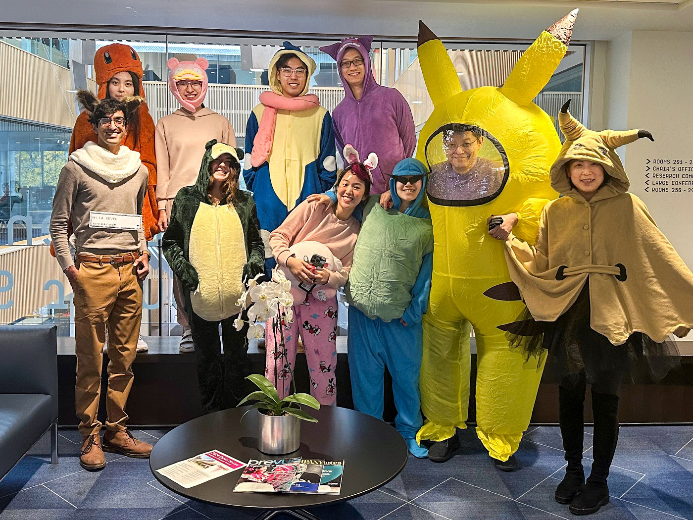 group of students and teachers posing in Halloween costumes