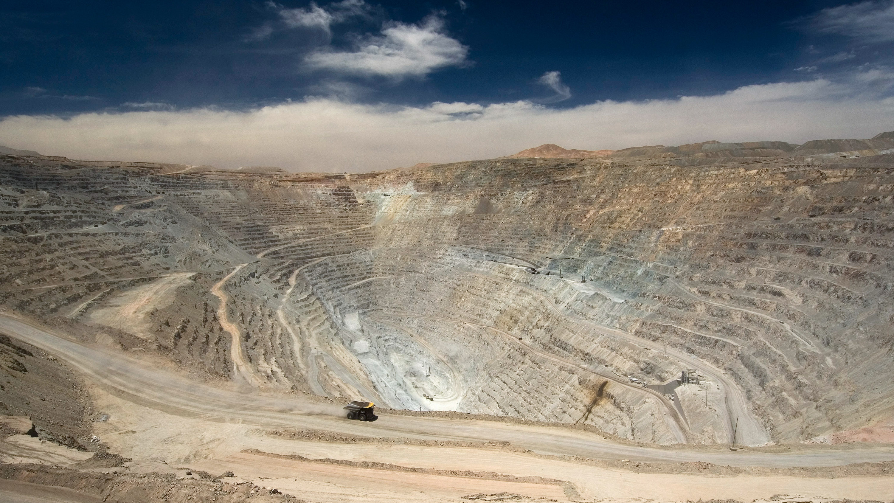 the dirt road past a large mining project with a single Ceibo truck driving through frame